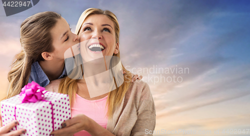 Image of daughter kissing mother and giving her present