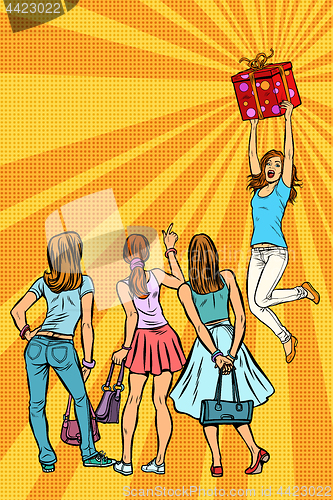 Image of Women shoppers look at the girl with a gift