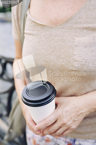 Image of Crop lady with hot beverage