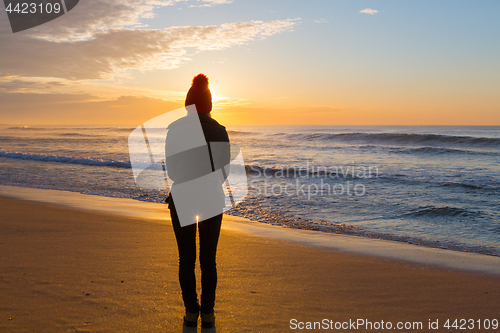 Image of Watching the sunrise from sandy seashore in winter