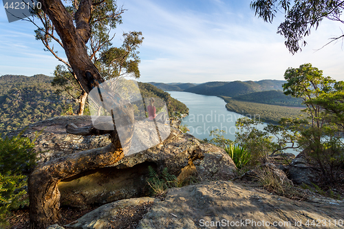 Image of Woman chillaxing with river views in Australian bushland