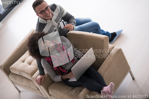 Image of multiethnic couple shopping online