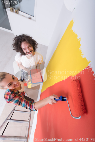 Image of couple painting interior wall