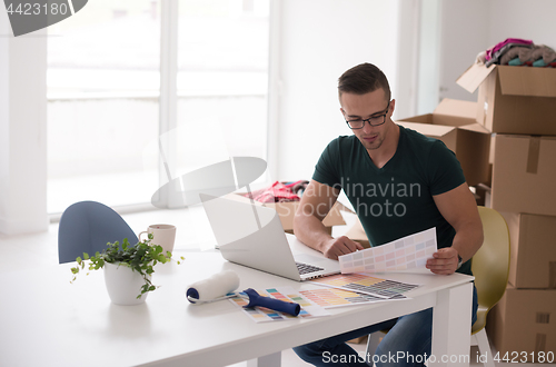Image of Young man moving in a new home