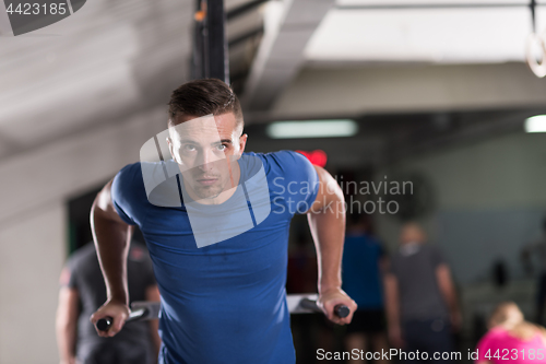 Image of man doing exercises parallel bars