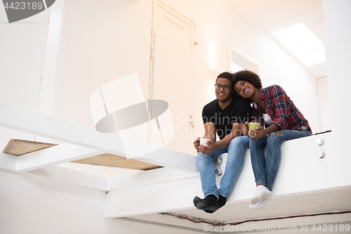 Image of couple having break during moving to new house