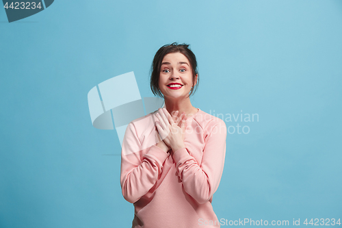 Image of Beautiful woman looking suprised isolated on blue