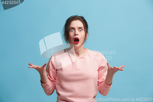 Image of The young emotional angry and scared woman standing and looking at camera