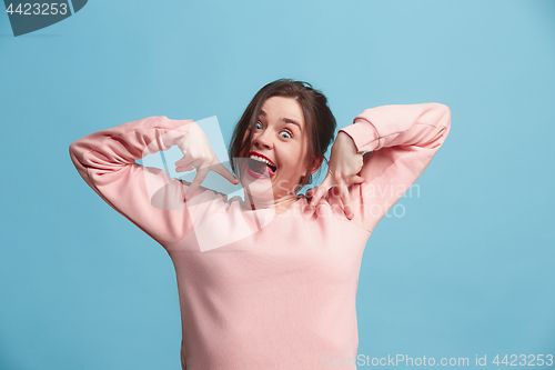 Image of The squint eyed woman with weird expression isolated on blue