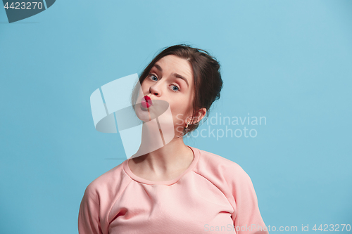 Image of Portrait of attractive cute girl with bright makeup with kiss isolated over blue background