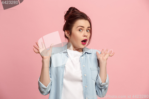 Image of Beautiful woman looking suprised isolated on pink