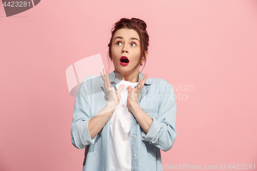 Image of Beautiful woman looking suprised isolated on pink