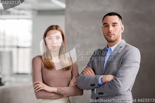 Image of smiling businesswoman and businessman at office