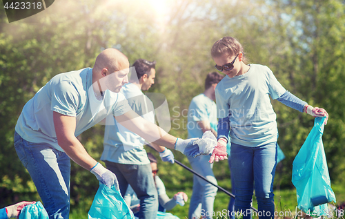 Image of volunteers with garbage bags cleaning park area