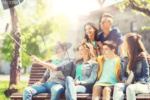 Image of happy teenage students taking selfie by smartphone