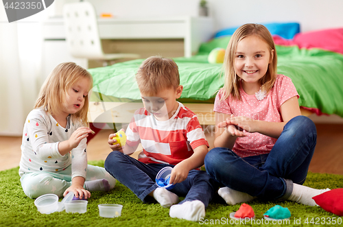 Image of kids with modelling clay or slimes at home