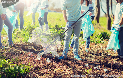 Image of volunteers with garbage bags cleaning park area