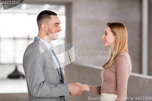 Image of smiling businesswoman and businessman at office