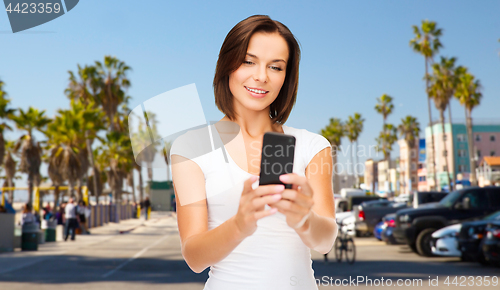 Image of woman taking selfie by smartphone in los angeles