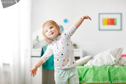 Image of happy little girl having fun at home