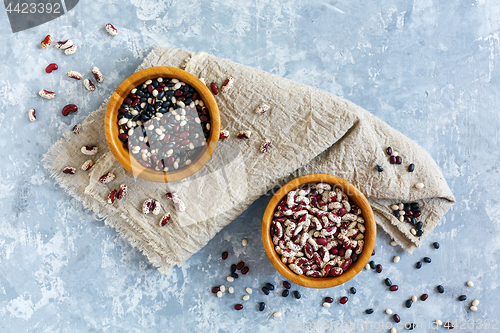 Image of Different types of beans in wooden bowls.