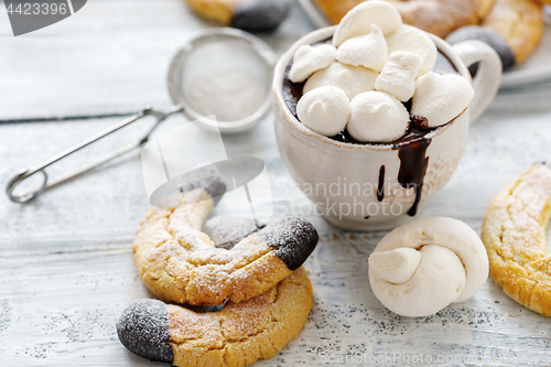 Image of Cup with hot chocolate and almond cookies.