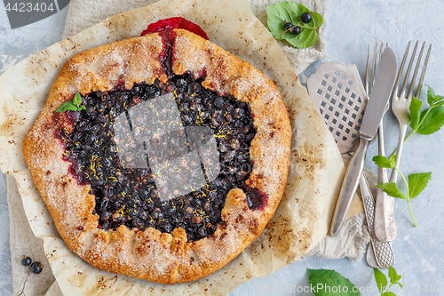 Image of Pie(Galette) with black currant and lemon zest.