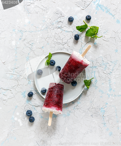 Image of Homemade coconut popsicles with fresh berry. 