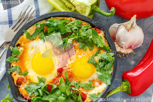 Image of Shakshuka in a cast iron pan closeup.