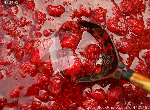 Image of Wooden spoon in jam from raspberry