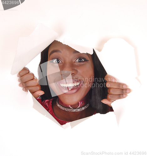 Image of Smiling woman looking trough hole