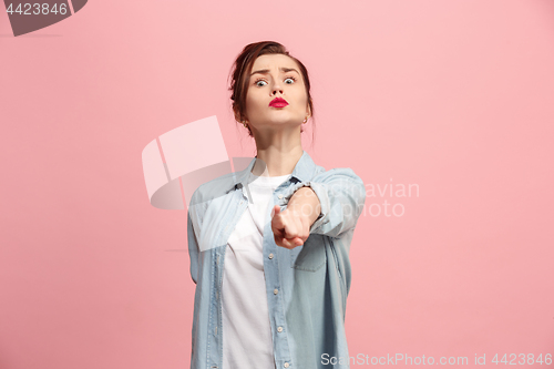 Image of The overbearing business woman point you and want you, half length closeup portrait on pink background.