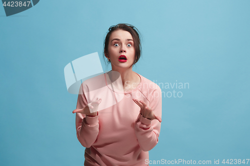 Image of Beautiful woman looking suprised isolated on blue