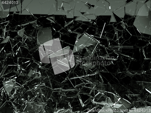 Image of Pieces of splitted or cracked glass on black