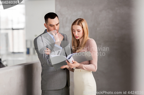 Image of businesswoman and businessman with folder