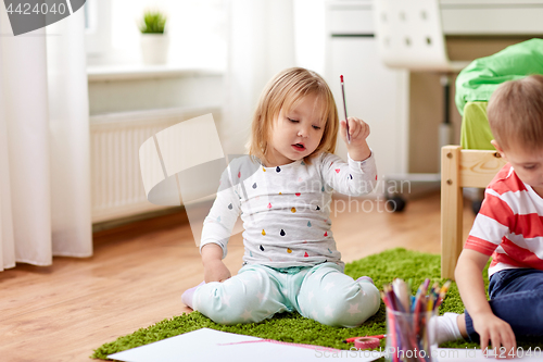 Image of happy kids drawing at home