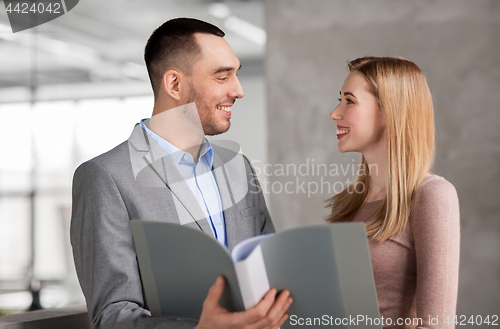 Image of businesswoman and businessman with folder