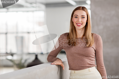 Image of happy smiling businesswoman at office