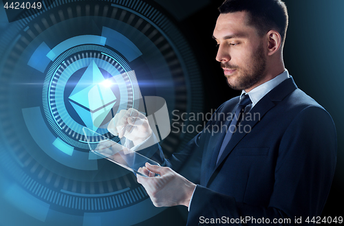 Image of businessman with tablet pc and ethereum hologram