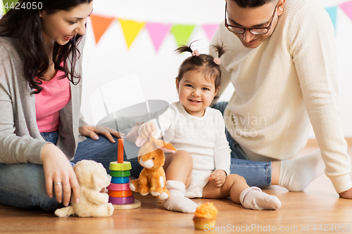 Image of baby girl with parents playing with toy rabbit