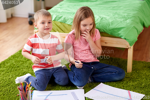 Image of happy kids drawing at home