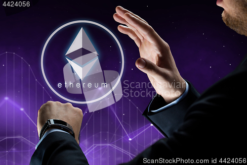 Image of hands with smart watch and ethereum hologram