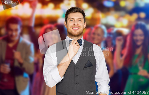 Image of man in festive suit over night club party