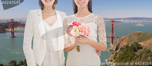 Image of female gay couple wedding over golden gate bridge