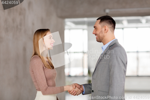 Image of smiling businesswoman and businessman at office