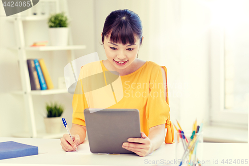 Image of asian woman student with tablet pc at home