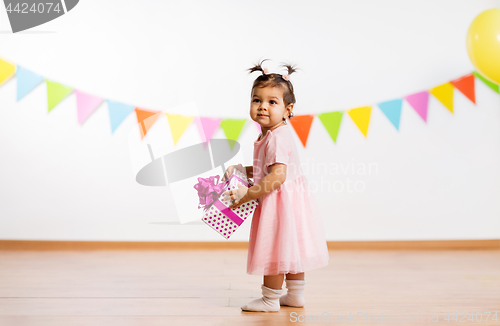 Image of happy baby girl with gift box on birthday party