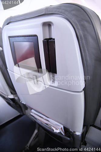 Image of Details of old seats blank screen monitor on the plane