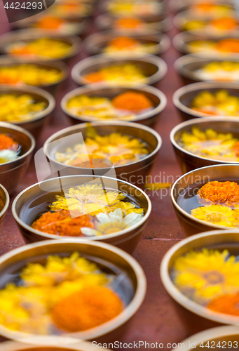 Image of Buddhist flower offerings or gifts in bowls and rows