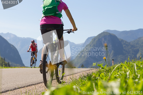 Image of Active sporty woman riding mountain bike in nature.